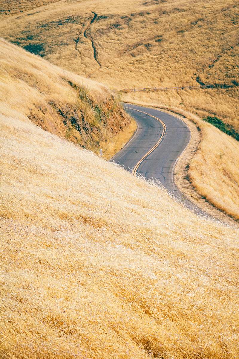highway empty curve road on slope during daytime freeway