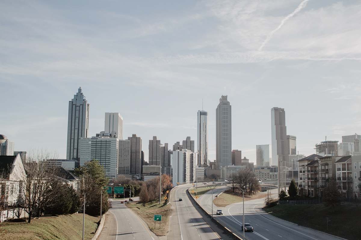 freeway high-rise buildings during daytime highway