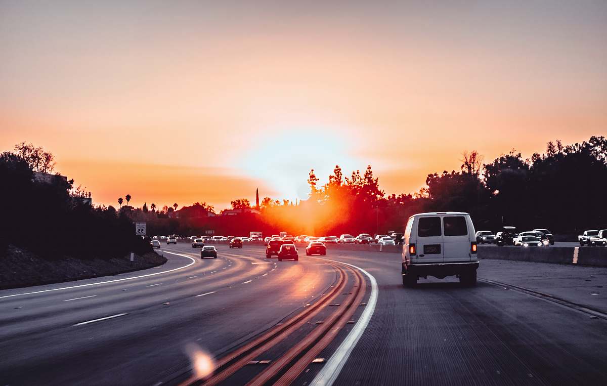 sunset white van on grey concrete road during golden hour freeway