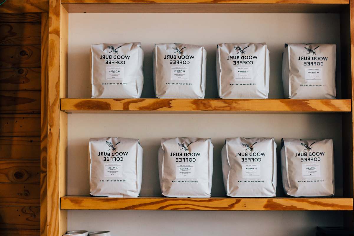 wood wood burl coffee packs on wooden shelf press coffee