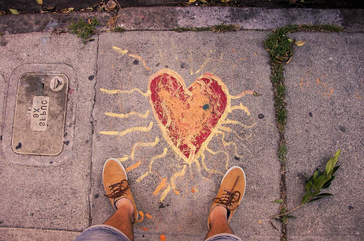 pavement person standing near heart paint san francisco