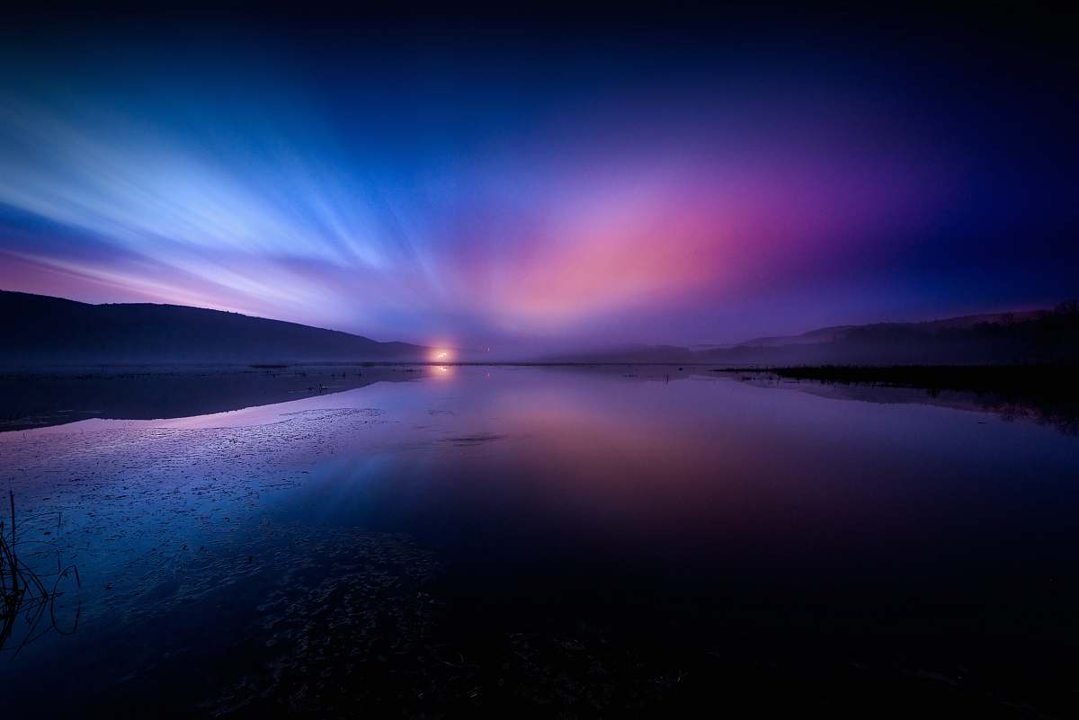 dusk landscape photography of body of water under dramatic sky sunrise