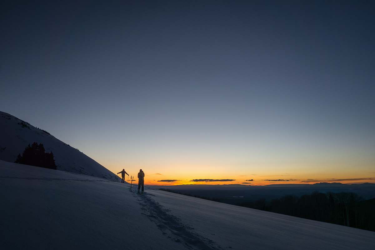sunset person standing on snowfield during daytime outdoors
