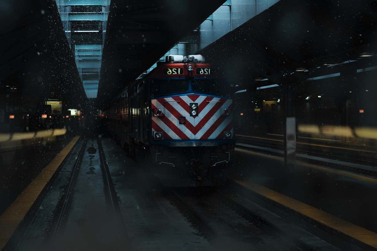 vehicle yellow and black train on rail track train station