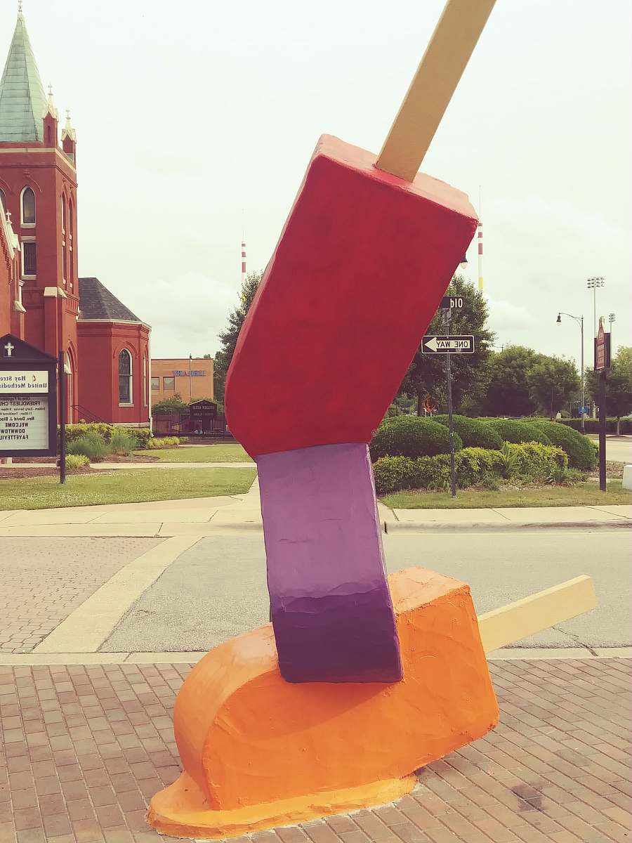 shovel pile of red, purple, and orange popsicles downtown