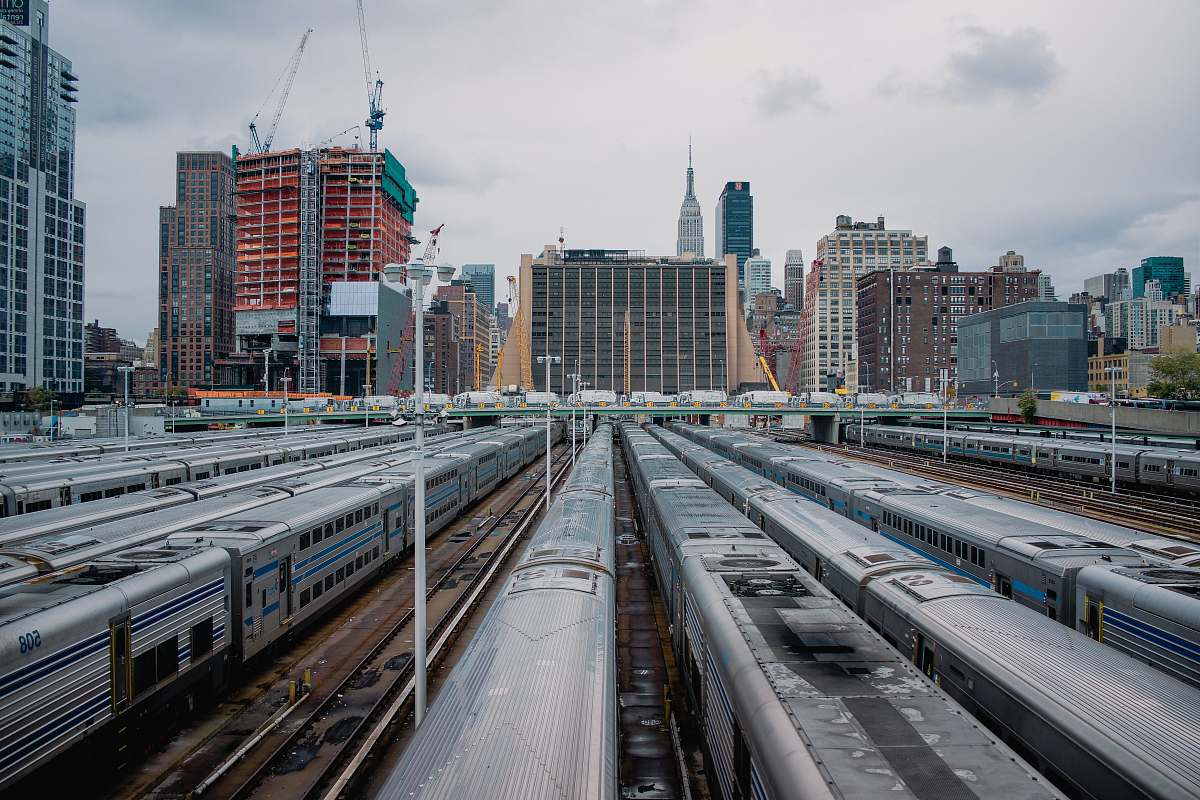 vehicle landscape photography of high-rise buildings train