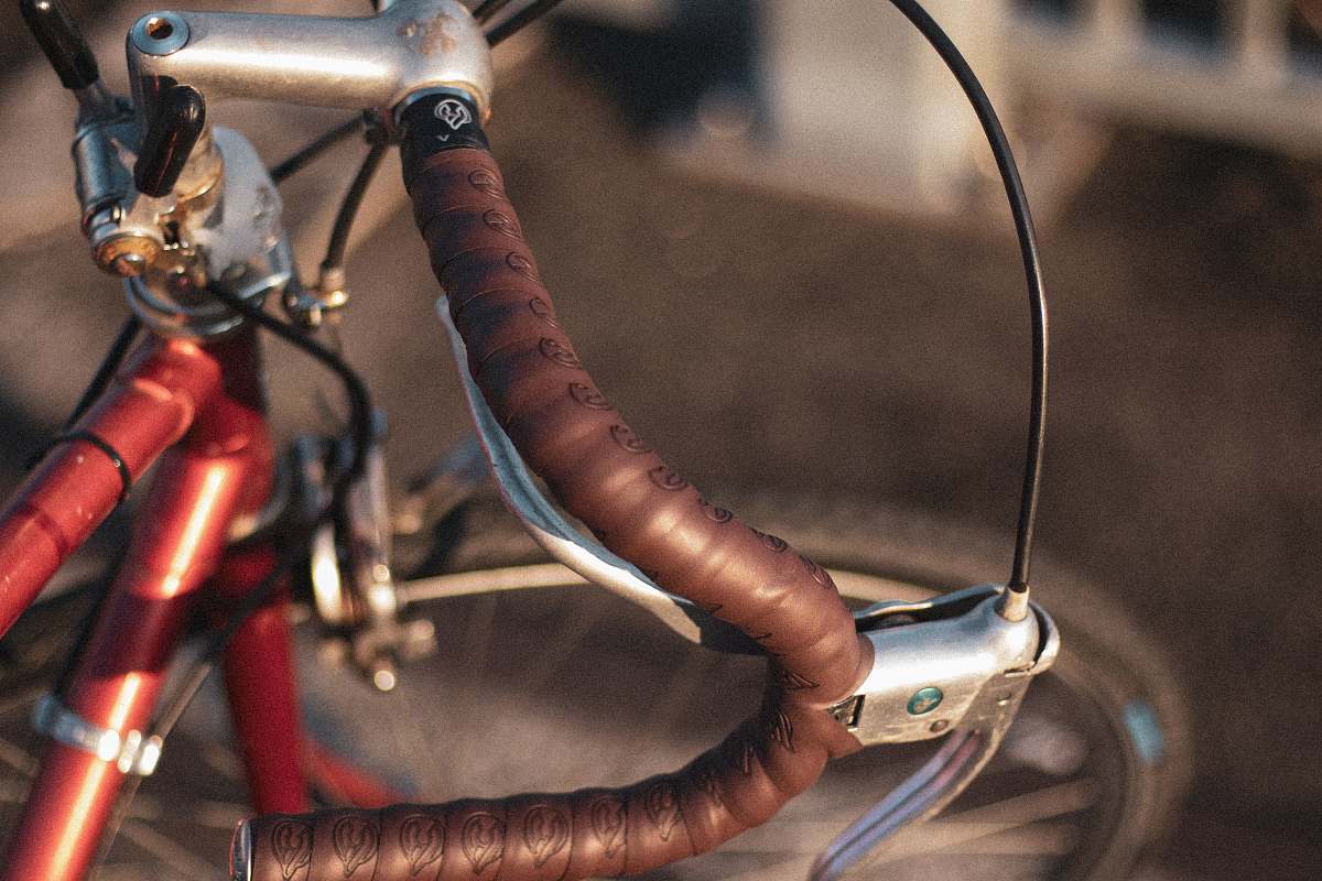 bike macro photography of red commuter bike handlebar bicycle