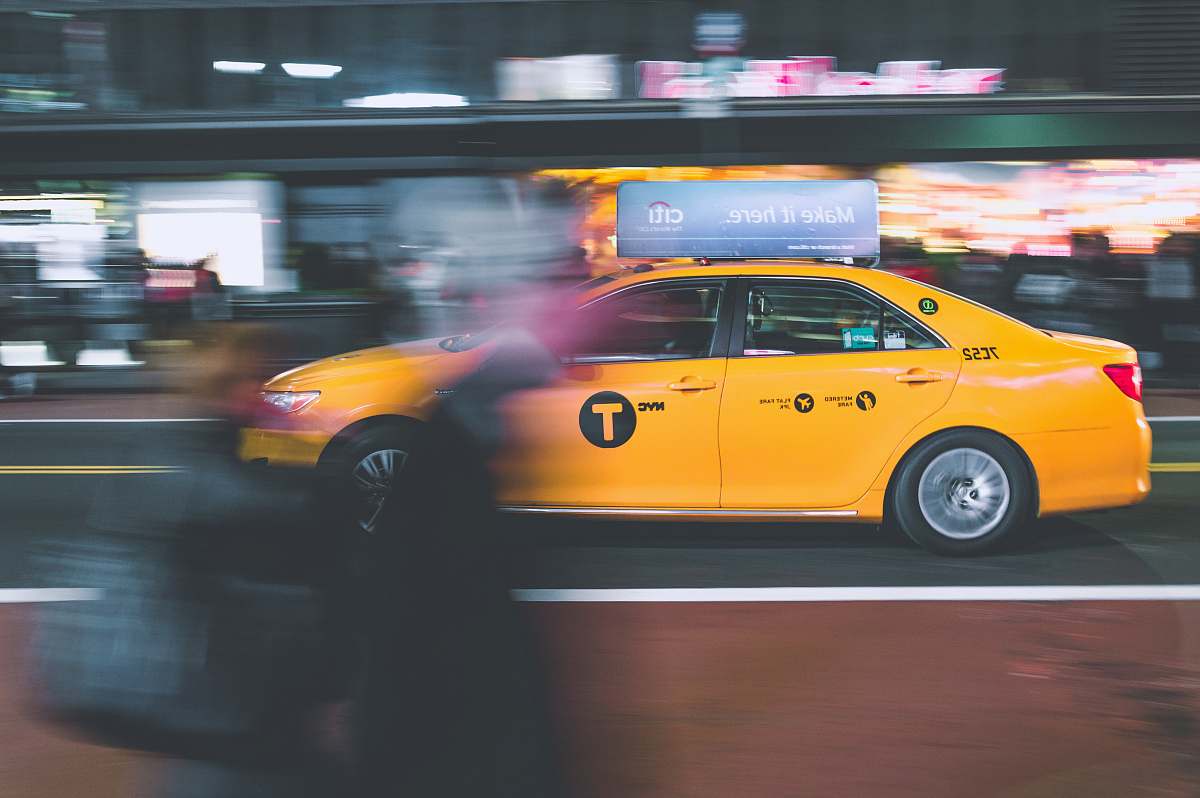 cab yellow sedan on gray road taxi