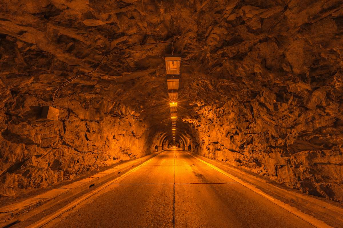 road tunnel road with orange light fixture dirt road