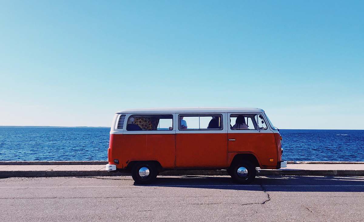 transportation white and red van near body of water bus