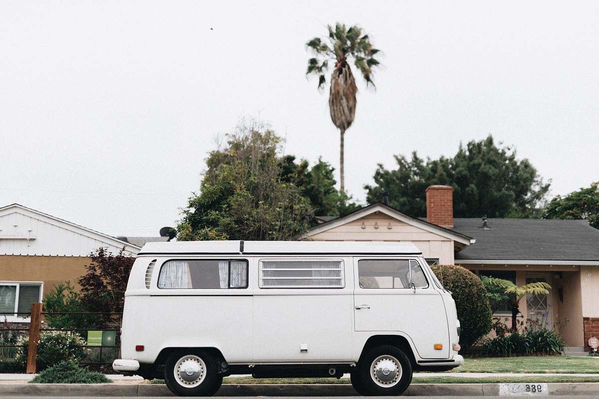 caravan white van in front of house transportation