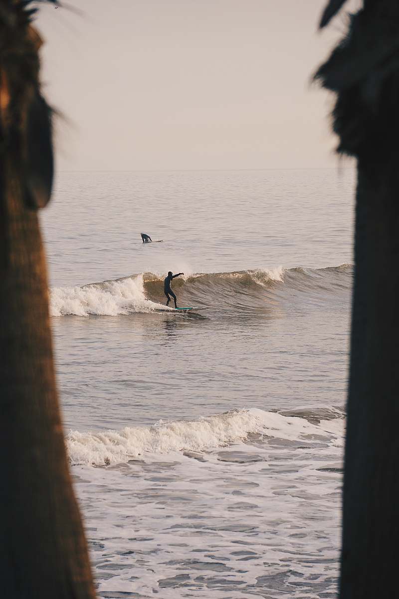 grey man surfing surfer