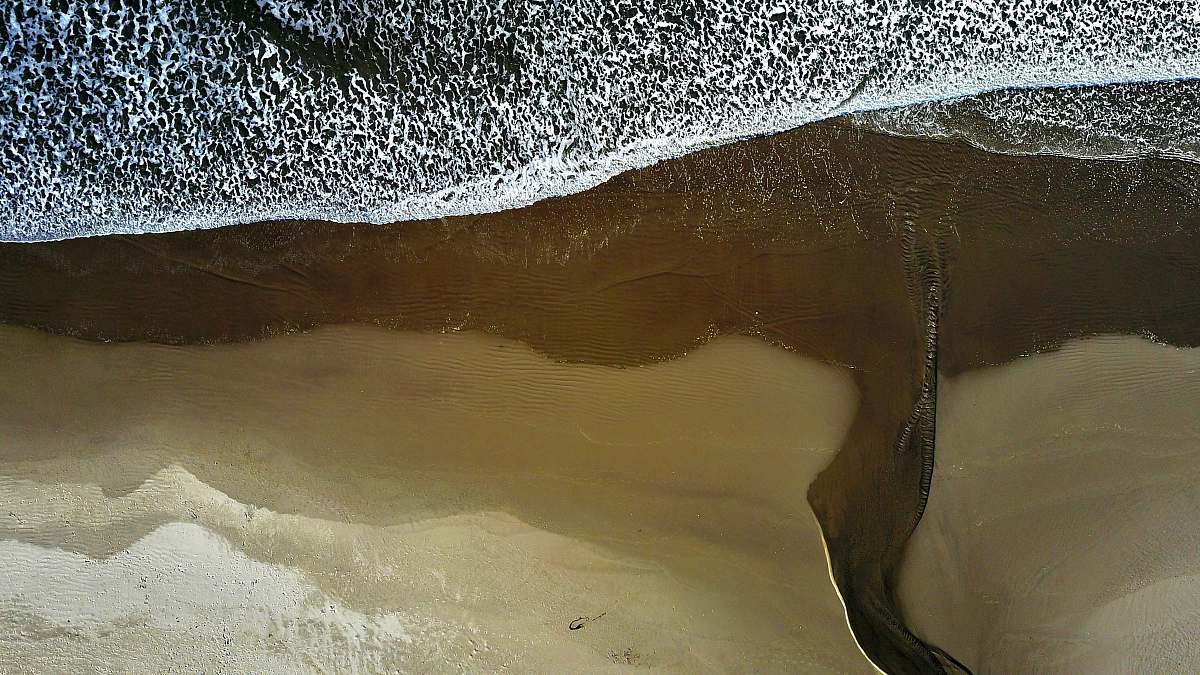 ocean Drone view of the ocean washing on the sand beach shoreline at Arch Cape, Oregon, United States sea