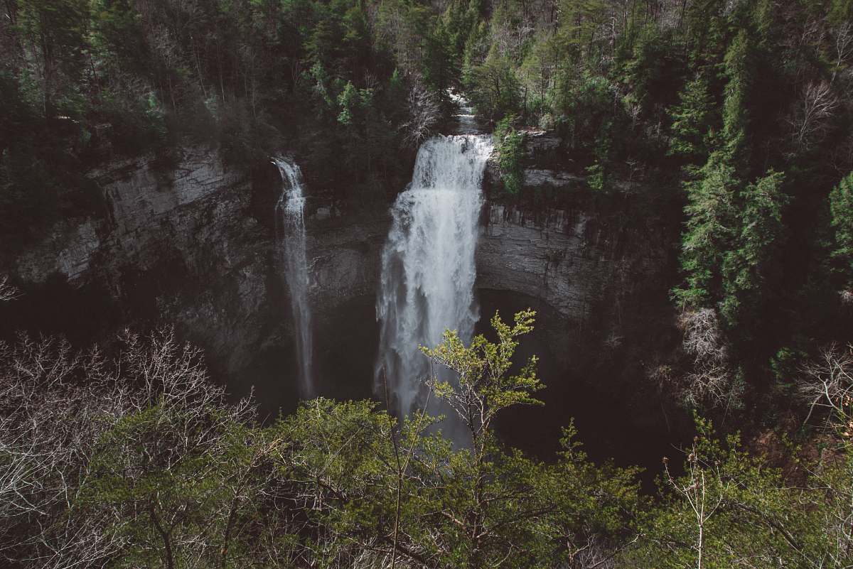 nature falls surrounded by trees on mountain during daytime river