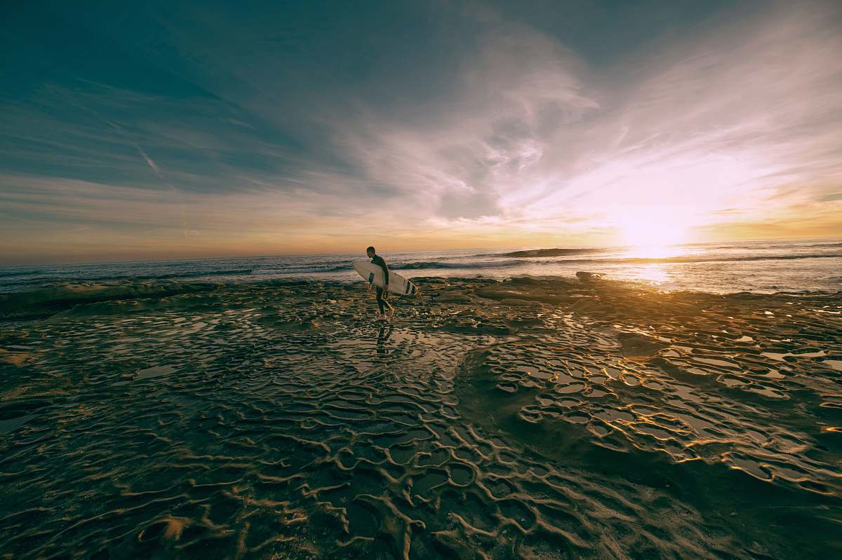 Beach Man Carrying White Surfboard While Walking On Shoreline At ...