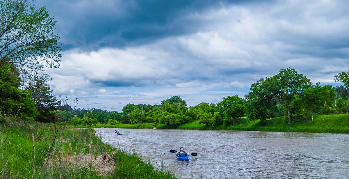 boat man kayaking on a river during daytime rowboat