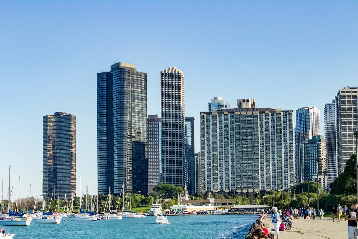 city people beside beach near buildings building