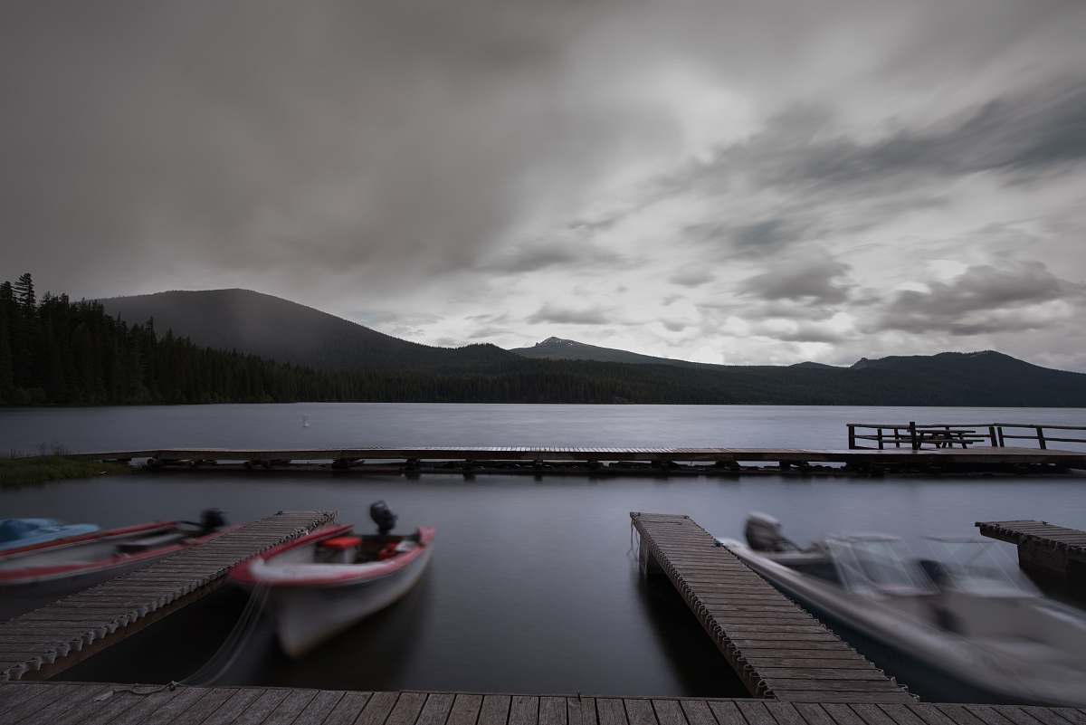 waterfront white boat near wooden dock over water dock