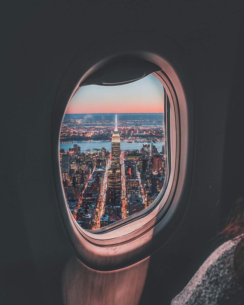porthole plane window photo of Empire State Building travel