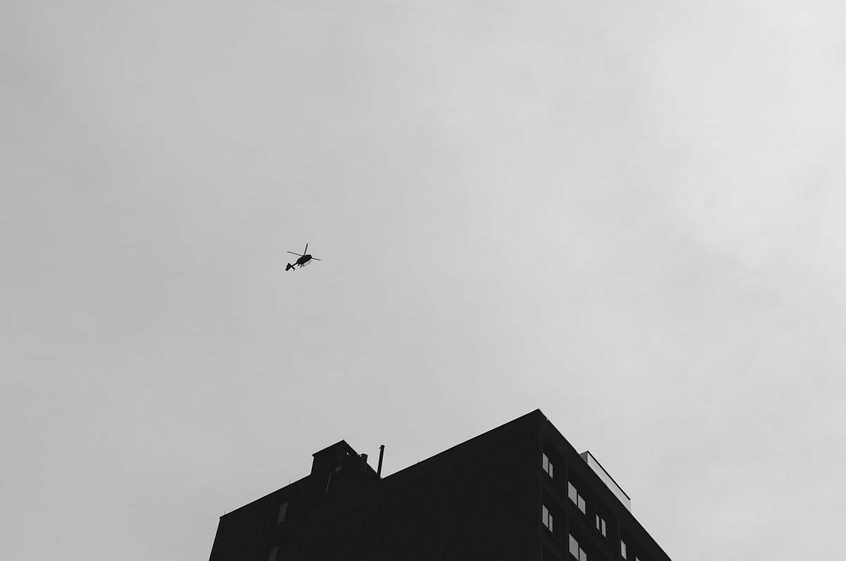animal black helicopter flying under cloudy sky during daytime black-and-white