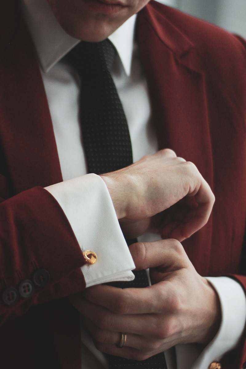 accessory man wearing maroon and white dress suit tie