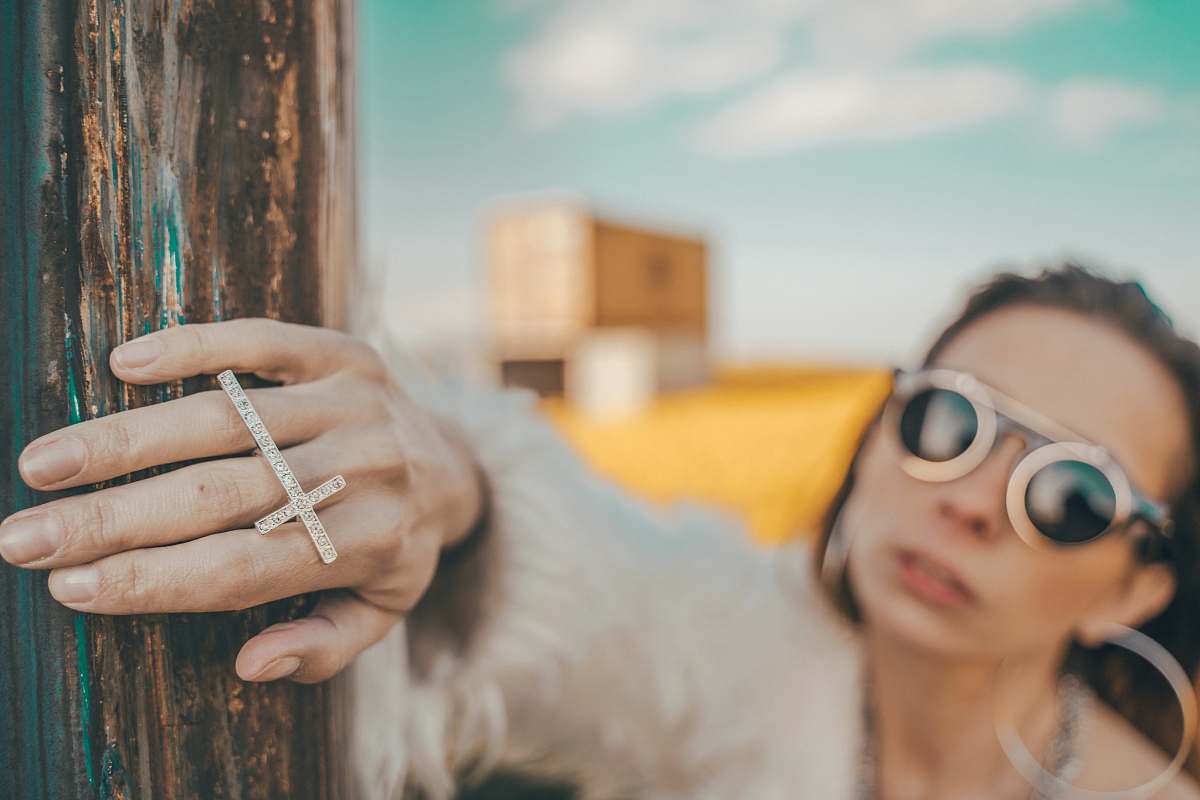 accessories selective focus photography of woman wearing gold-colored cross ring sunglasses
