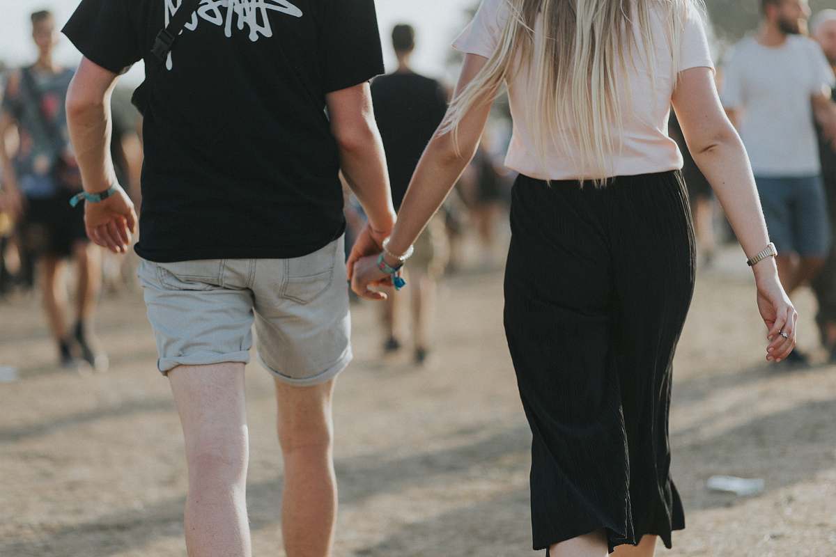 clothing couple holding hands while walking shorts