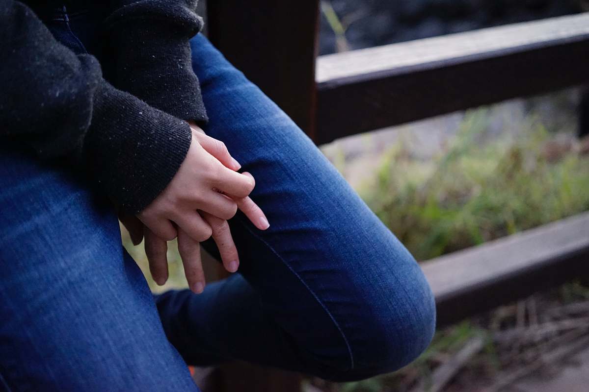 clothing person sitting on wooden fence pants