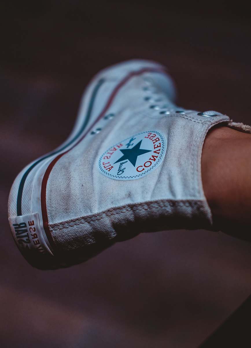 clothing selective focus photography of person wearing white Converse All-Star high-top sneaker footwear