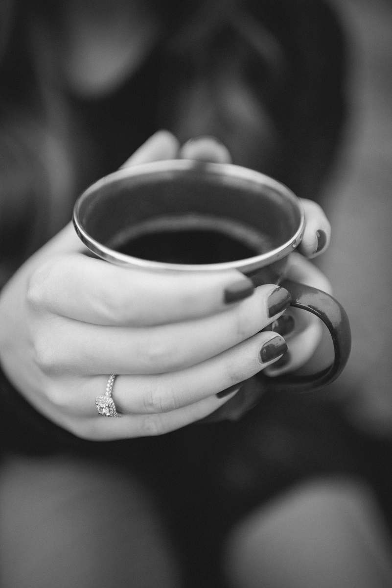 cup grayscale photography of person holding mug coffee cup