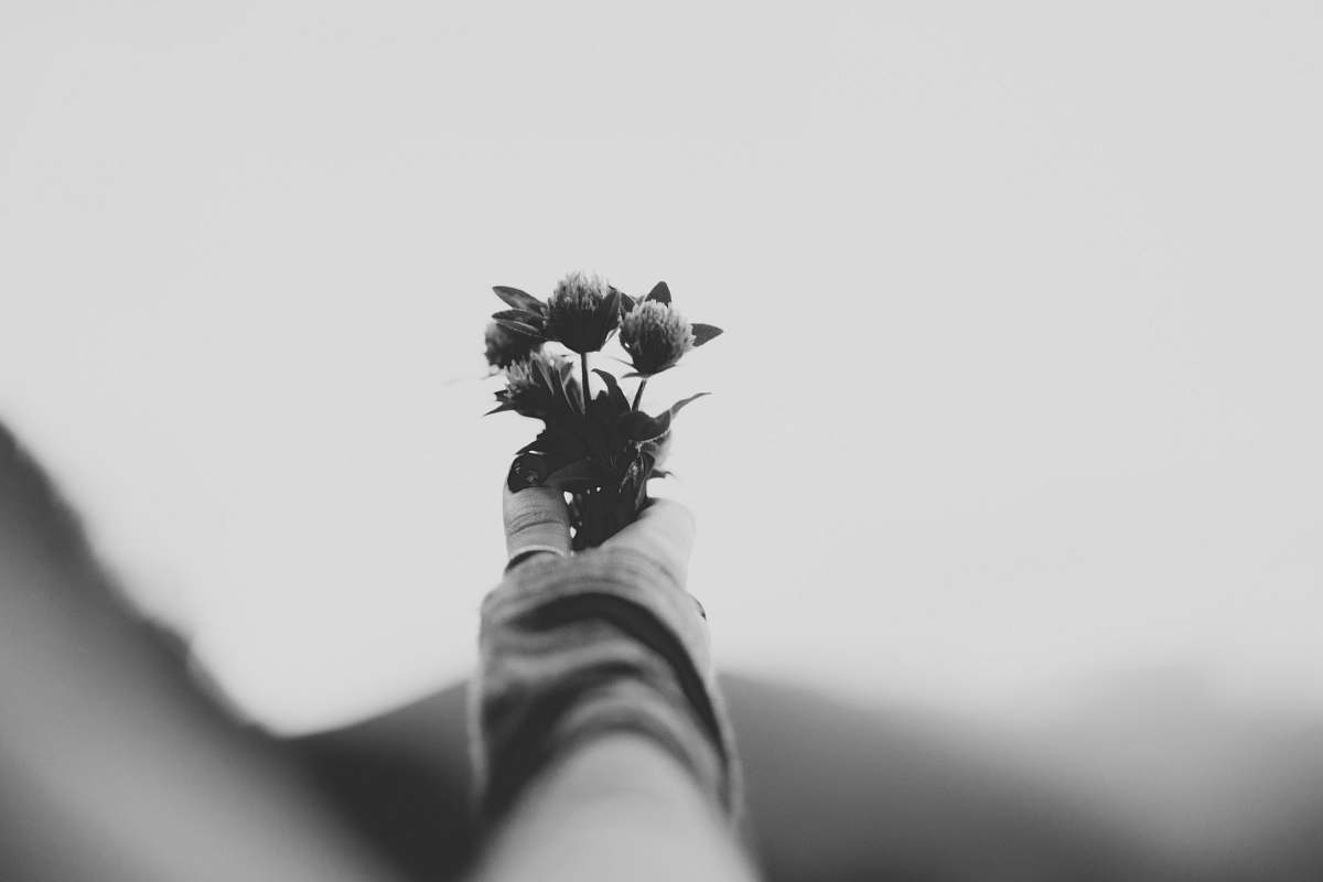 flower grayscale selective focus photon of person holding glowers flowers