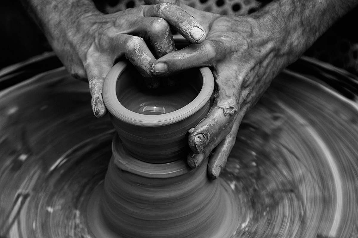 hands Messy hands sculpting on a pottery wheel in motion pottery