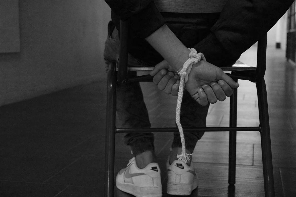 clothing person tied up on a chair apparel