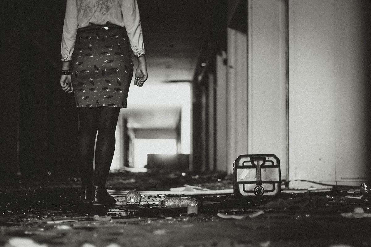 grey woman wearing skirt beside white building girl