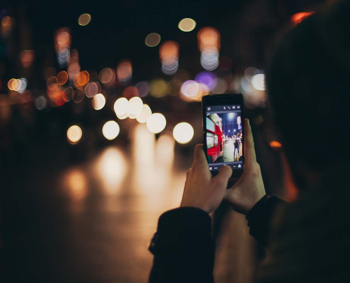 night person holding black Android smartphone gambling
