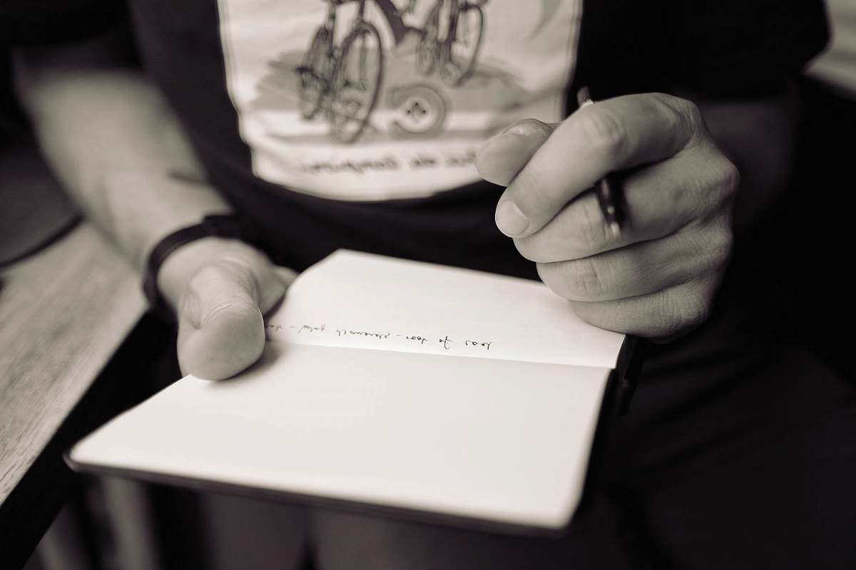 writing person writing on notepad hands