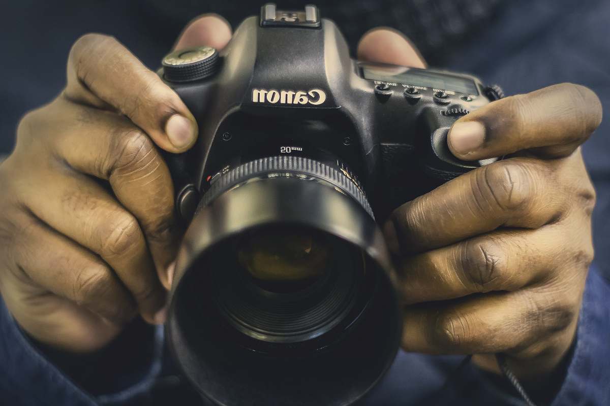 canon person holding DSLR camera dslr