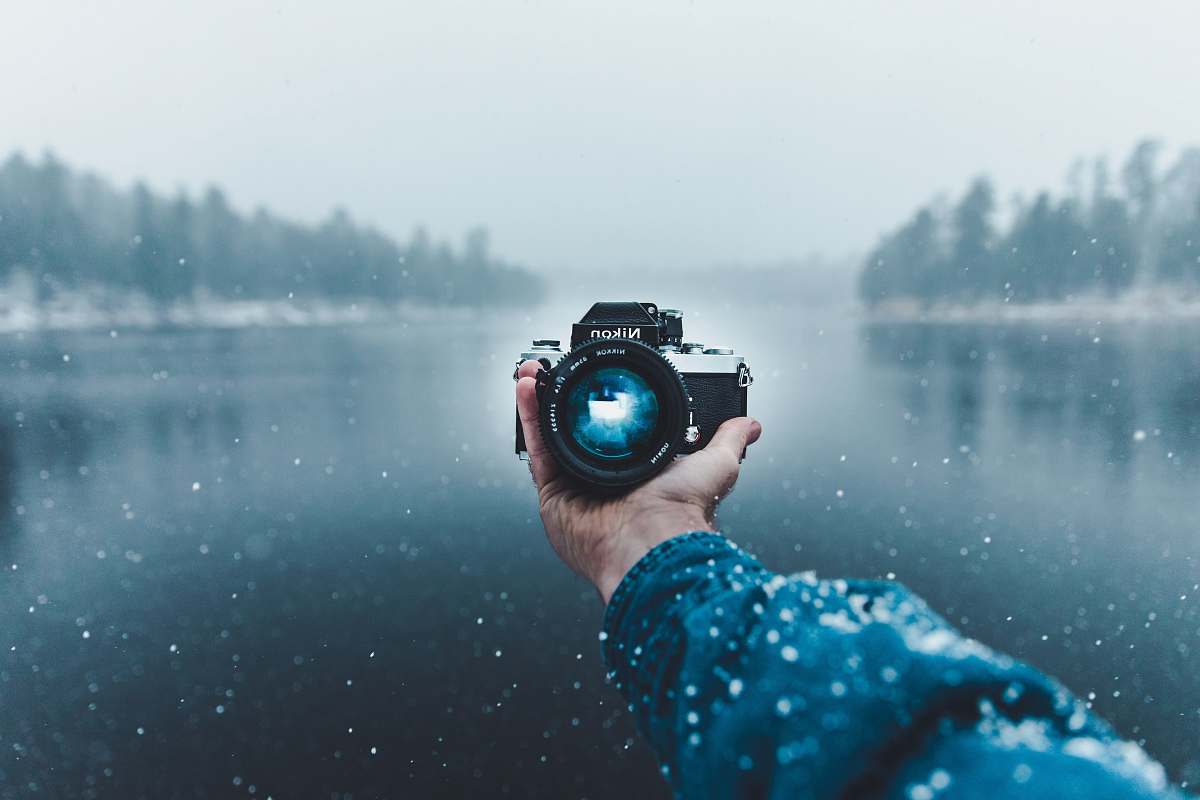person person taking selfie using Nikon DSLR camera nikon
