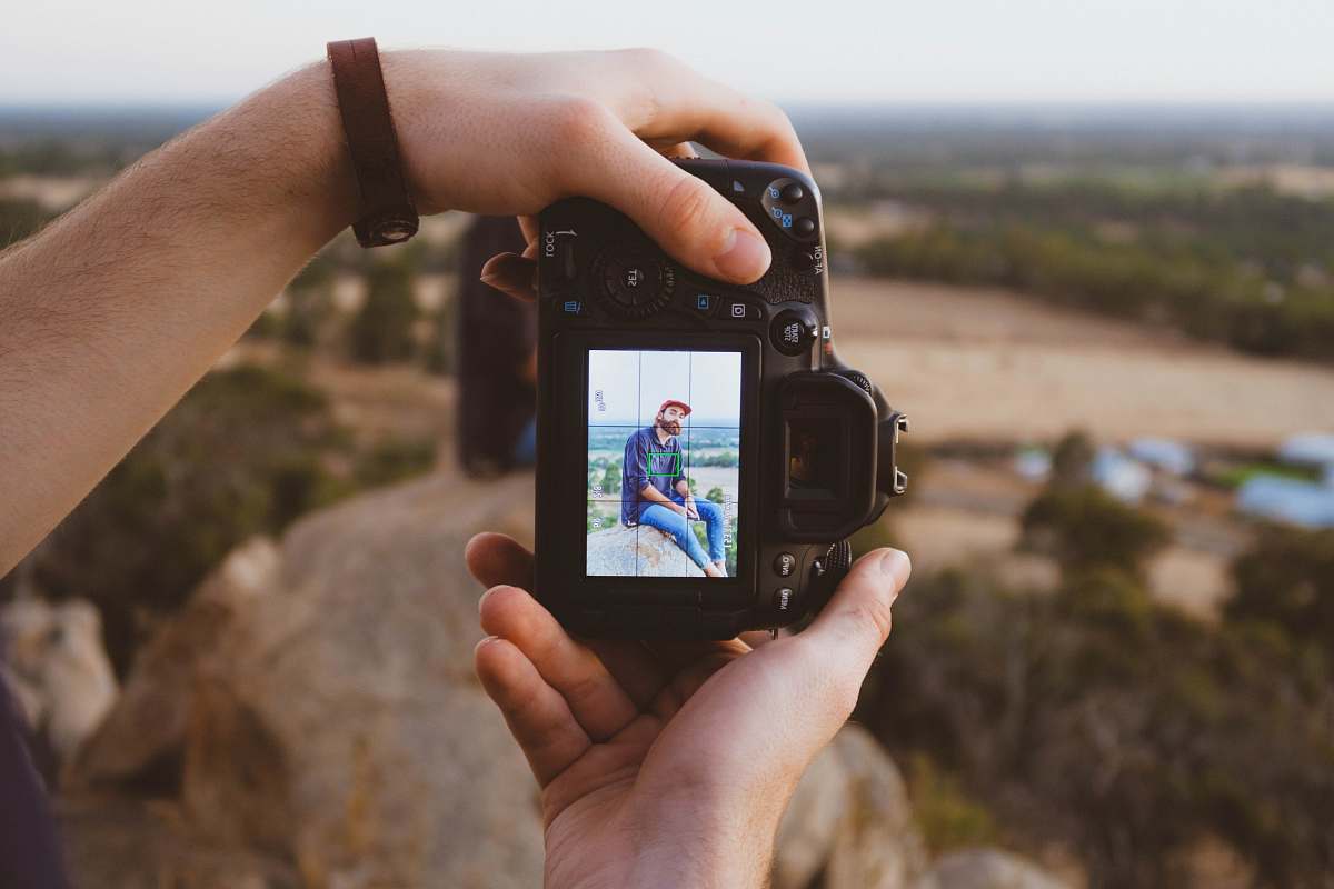 human person using black DSLR camera person