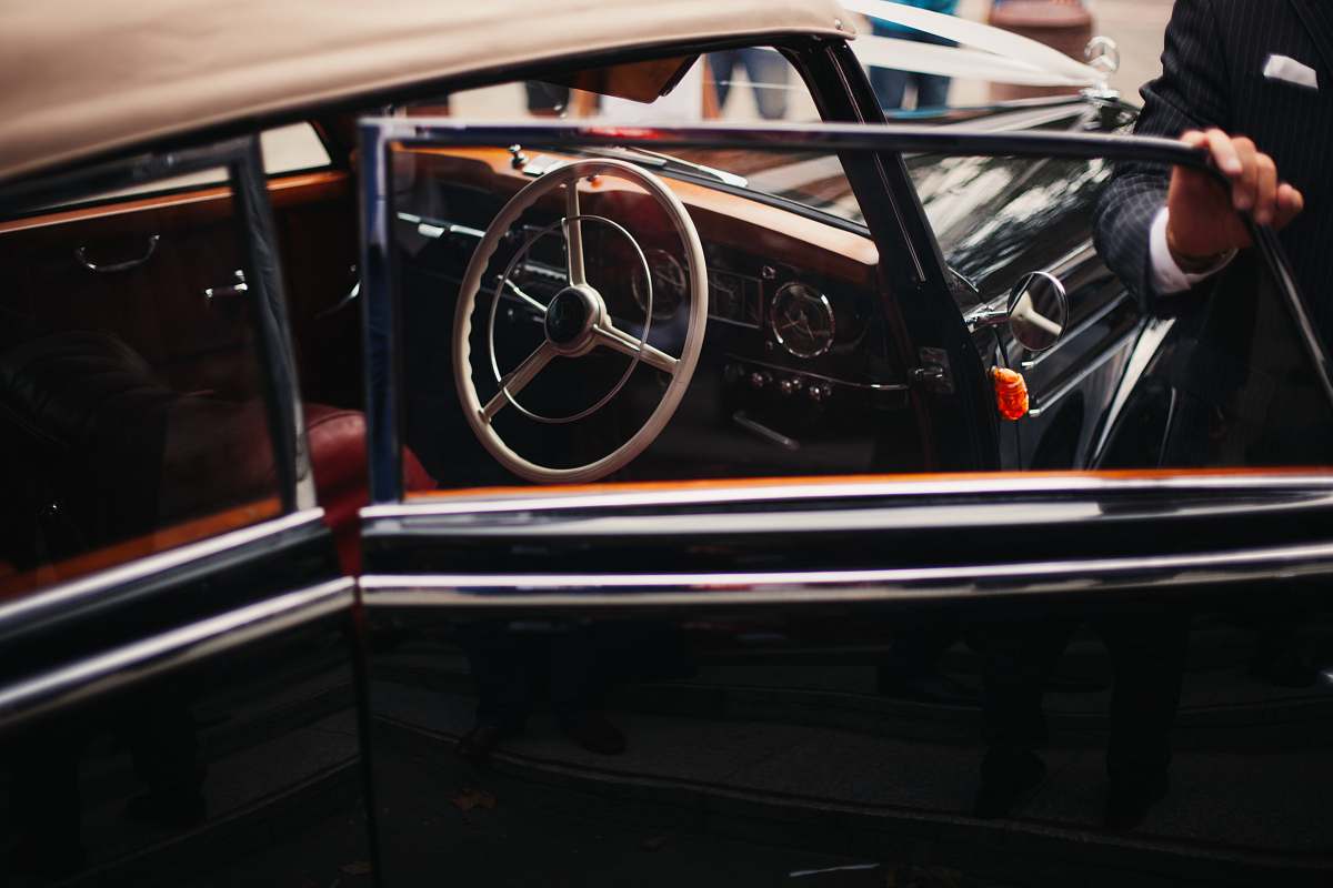 vintage person open vehicle door london