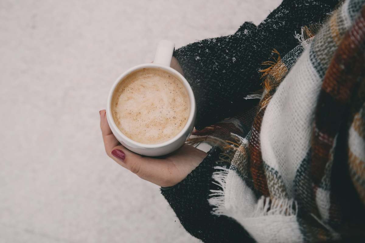 cup person holding white ceramic mug winter