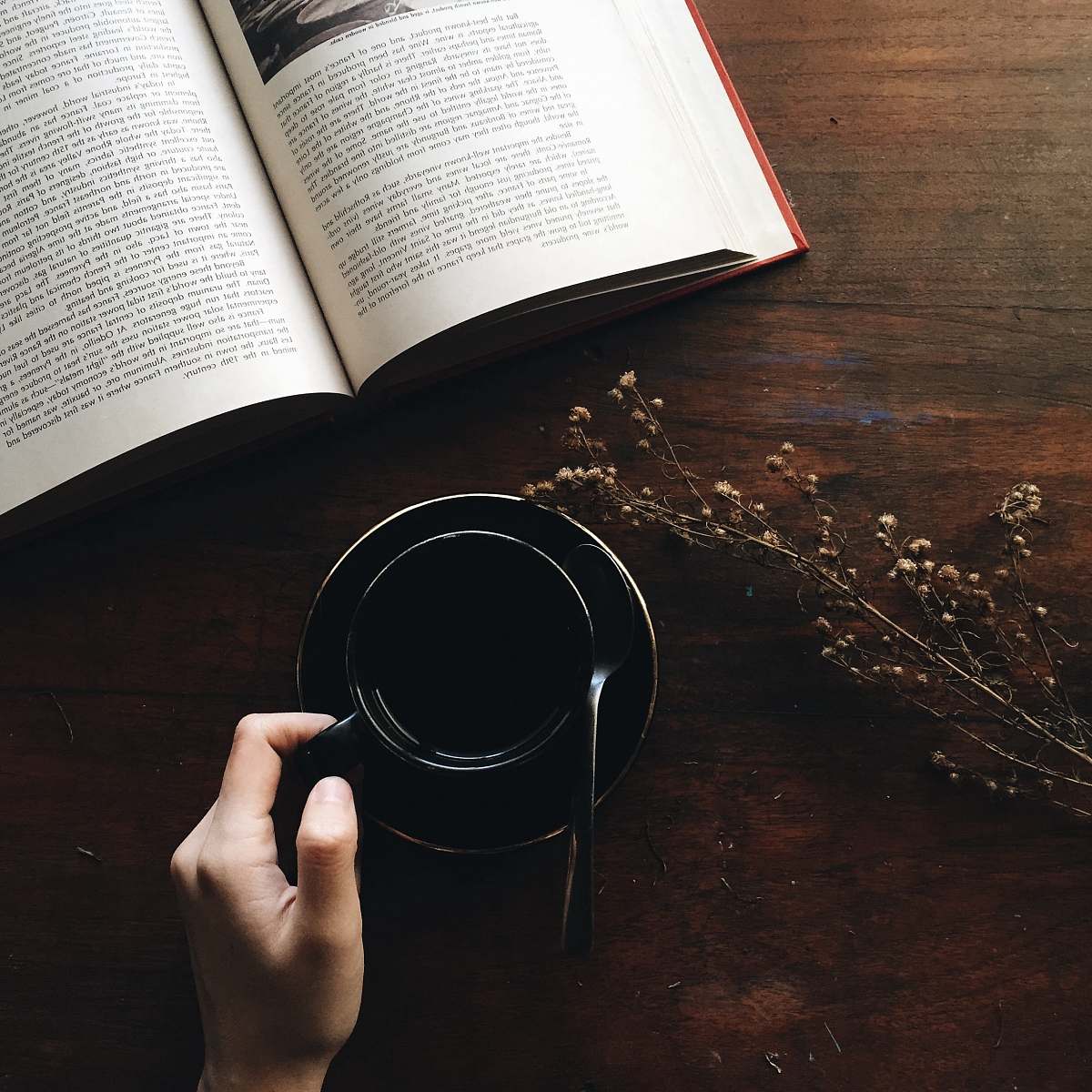book round black metal container near white book open reading