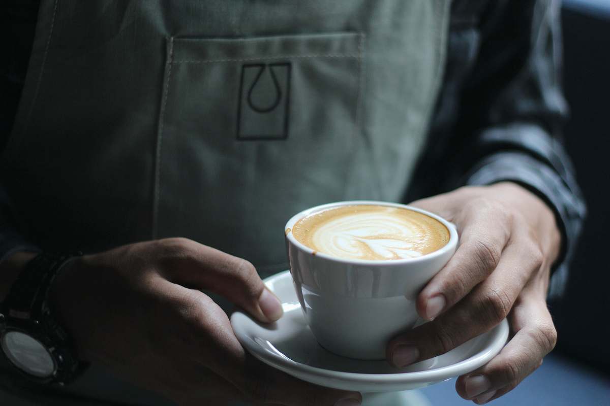 saucer person holding white ceramic cup mug