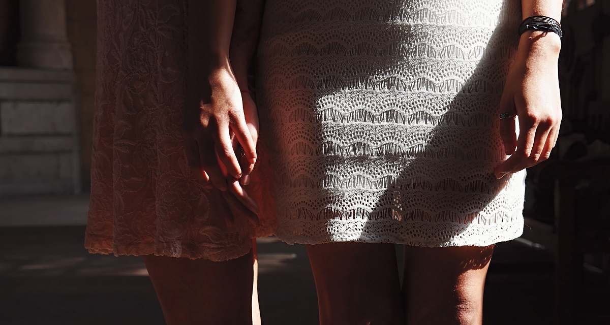 women woman holding other woman hand ankle