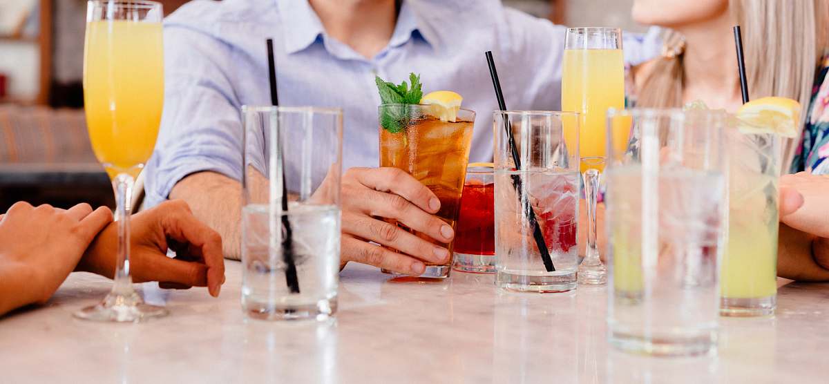 drink water goblets and highball glasses on the tables friends