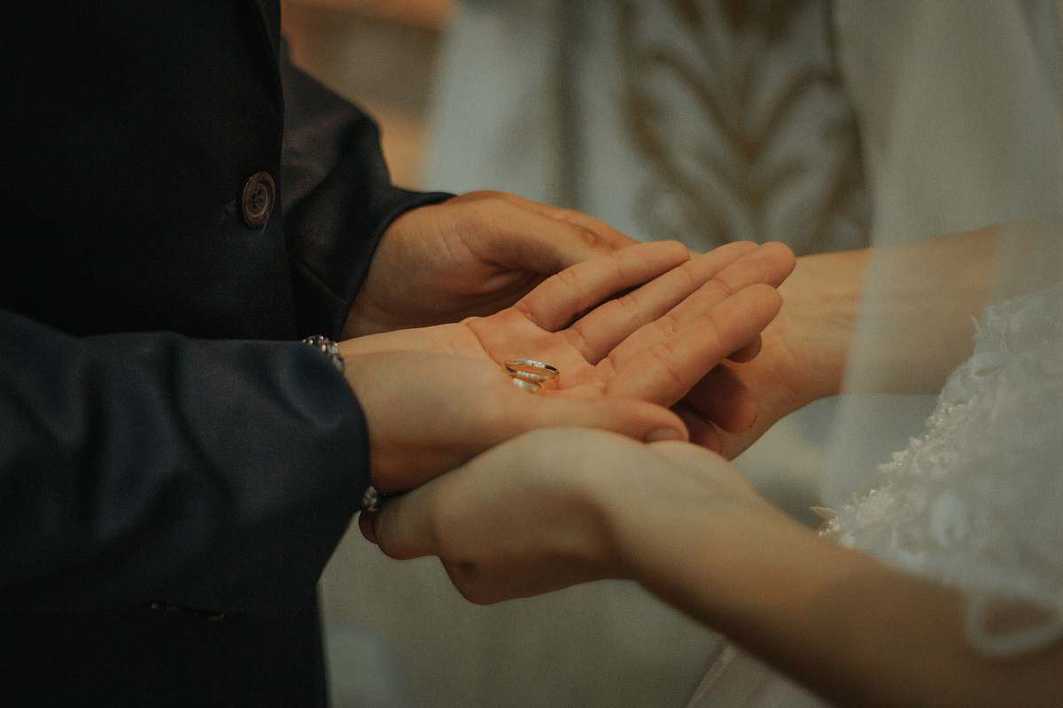 human man and woman holding hands with ring on hand person