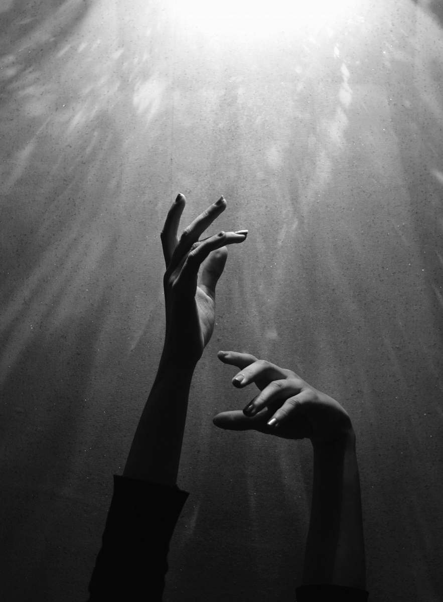 black-and-white person raising both hands grey