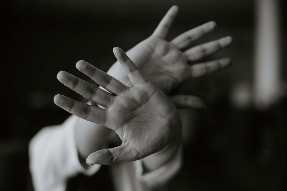 grey person stretching their hands libya