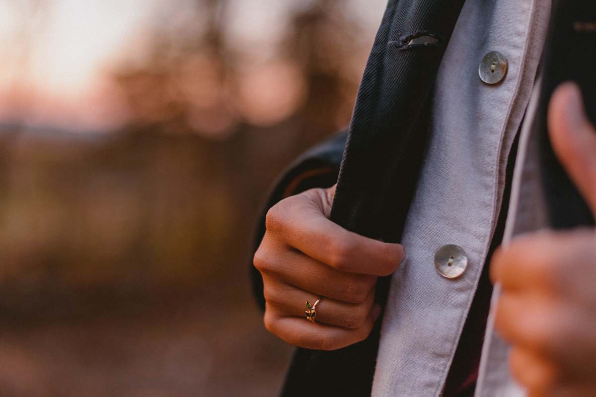 human person touching blazer coat