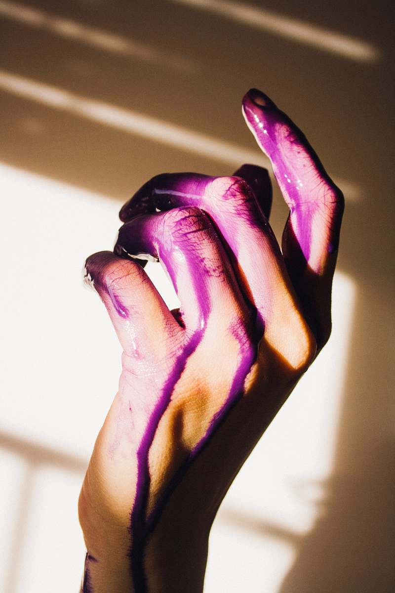 hand purple paint on hand person